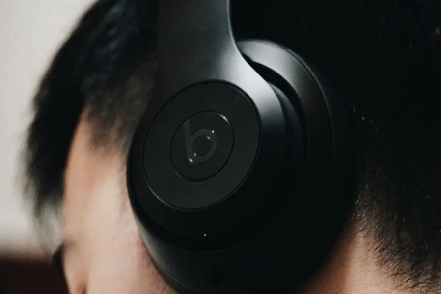 man wearing black Beats headphones