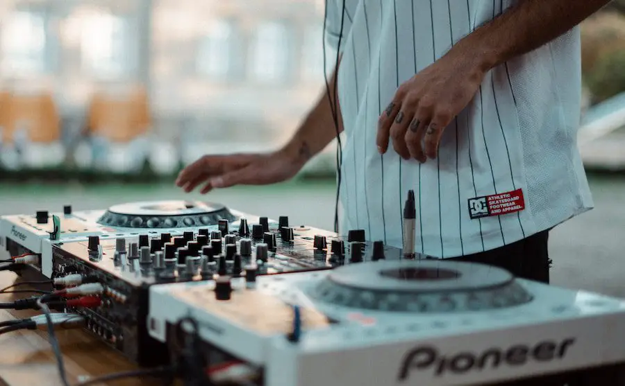 man playing Pioneer DJ controller makes a mashup
